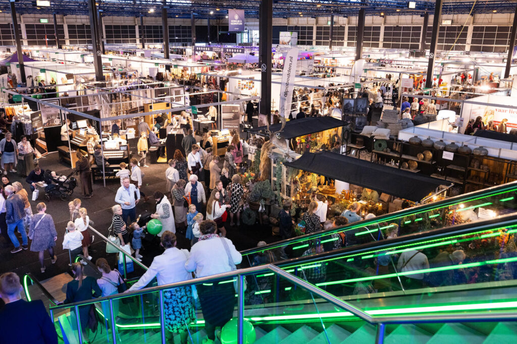 Drukke beursvloer met stands en bezoekers