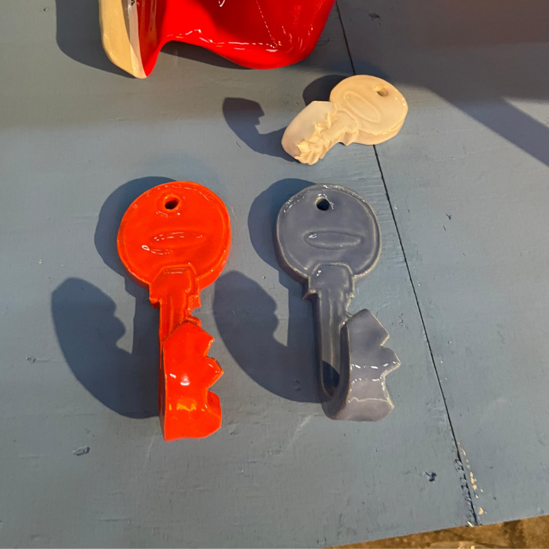 Gekleurde keramische sleutels op een blauwe tafel