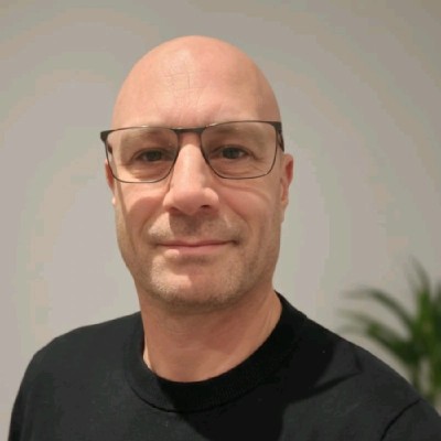 Portret van kale man met bril en zwarte trui