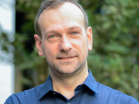 COM - Claude Van Opstal