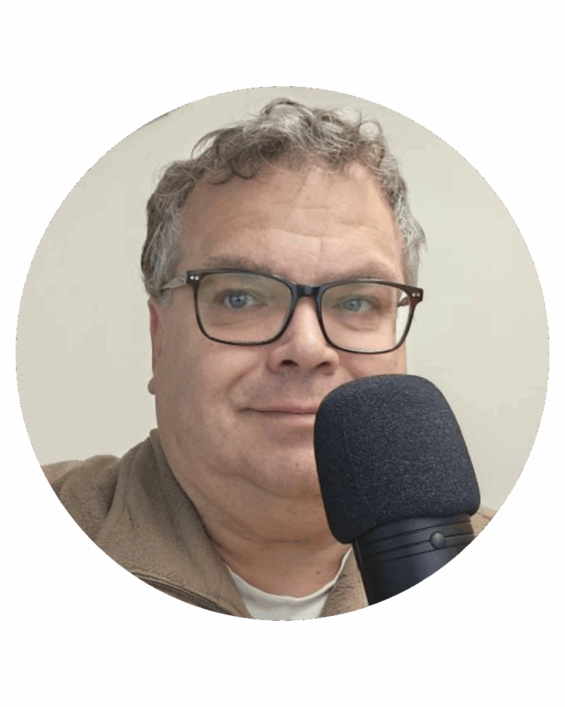 Man met bril spreekt in een microfoon