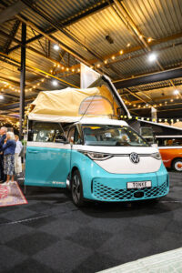 Turquoise Volkswagen ID. Buzz met hefdak op beurs