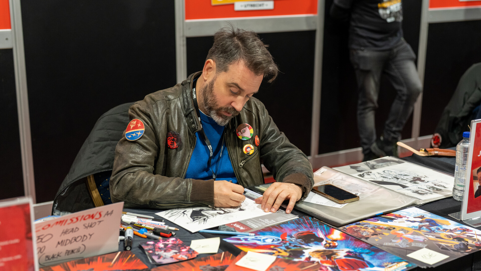 Comic artist drawing a commission piece at Heroes Dutch Comic Con