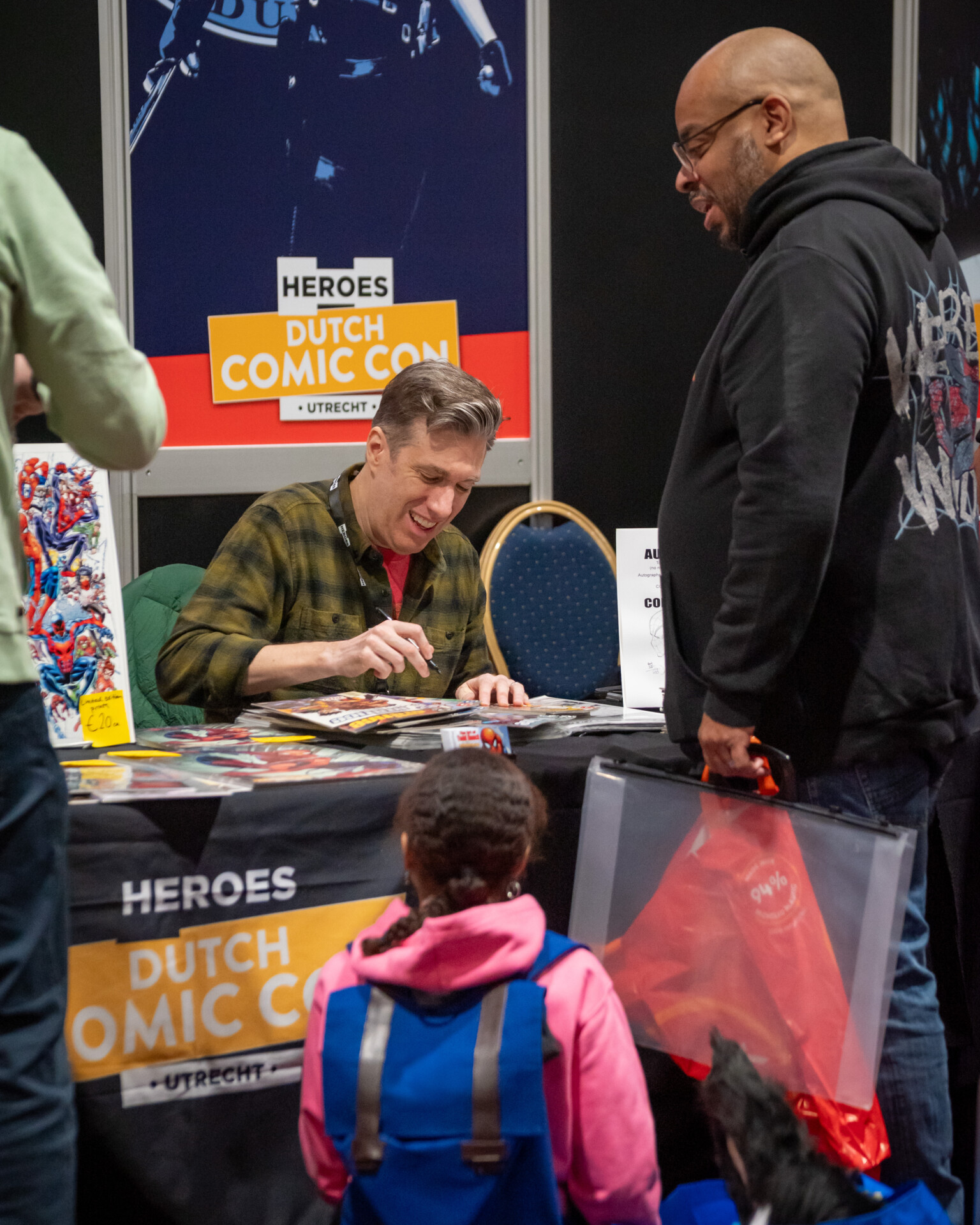 Comic artist signing an autograph at Heroes Dutch Comic Con