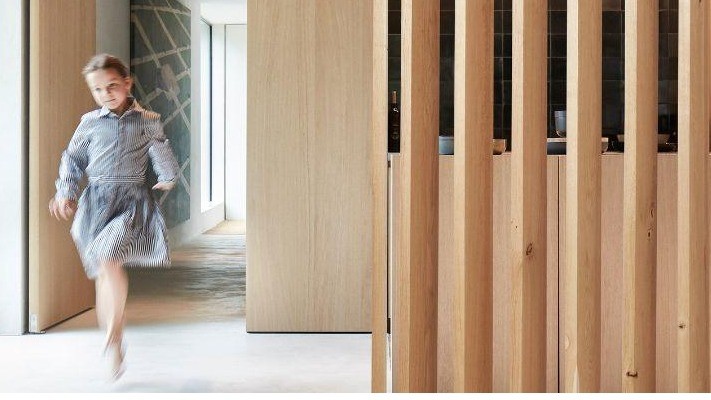 Wooden plantation shutters as room dividers: a design feature for playing with light, privacy and acoustics