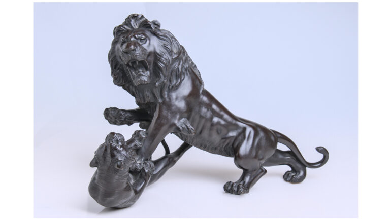 Large bronze of a lion fighting a tiger