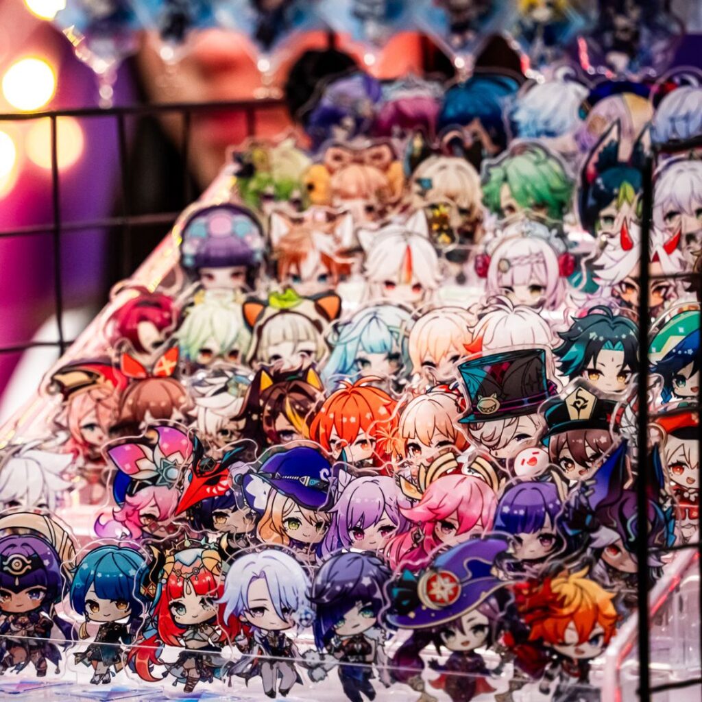 Close up of Genshin Impact charms from Artist Alley