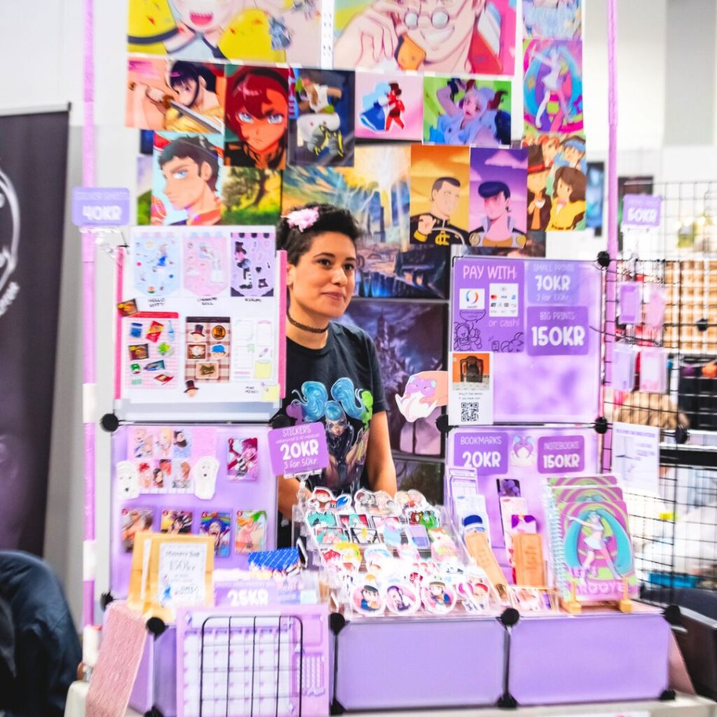 Person selling their own art in Artist Alley