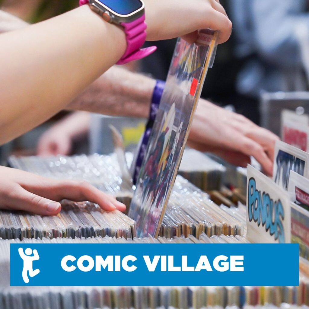Person browsing through wrapped comics with a blue overlay banner with "comic village" written on it.