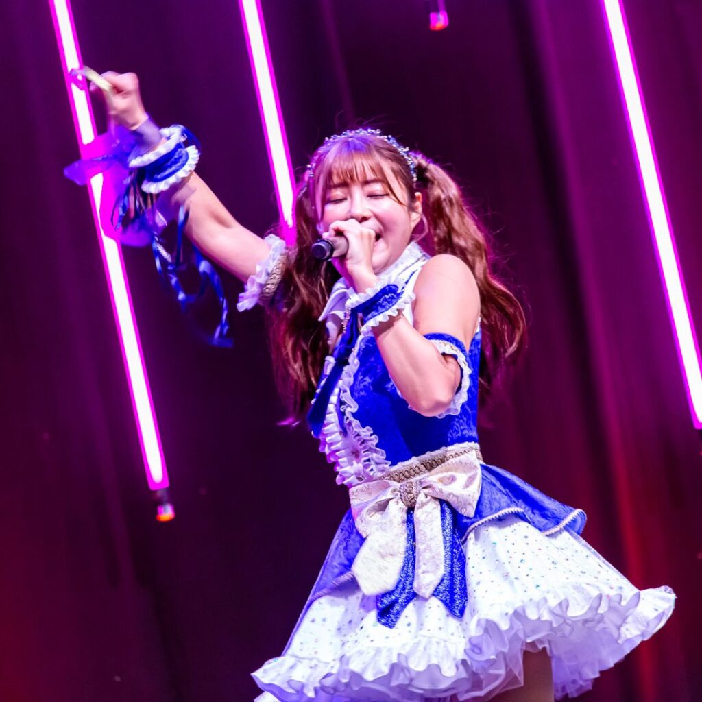 Misa idol dancing on stage in blue costume