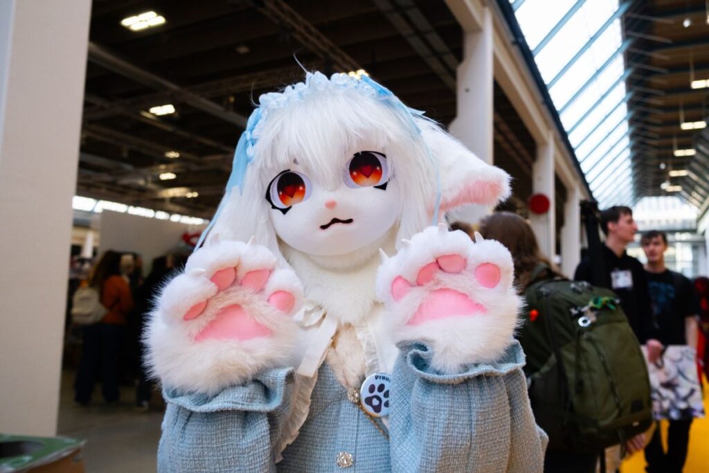 Person in a fursuit waving at the camera