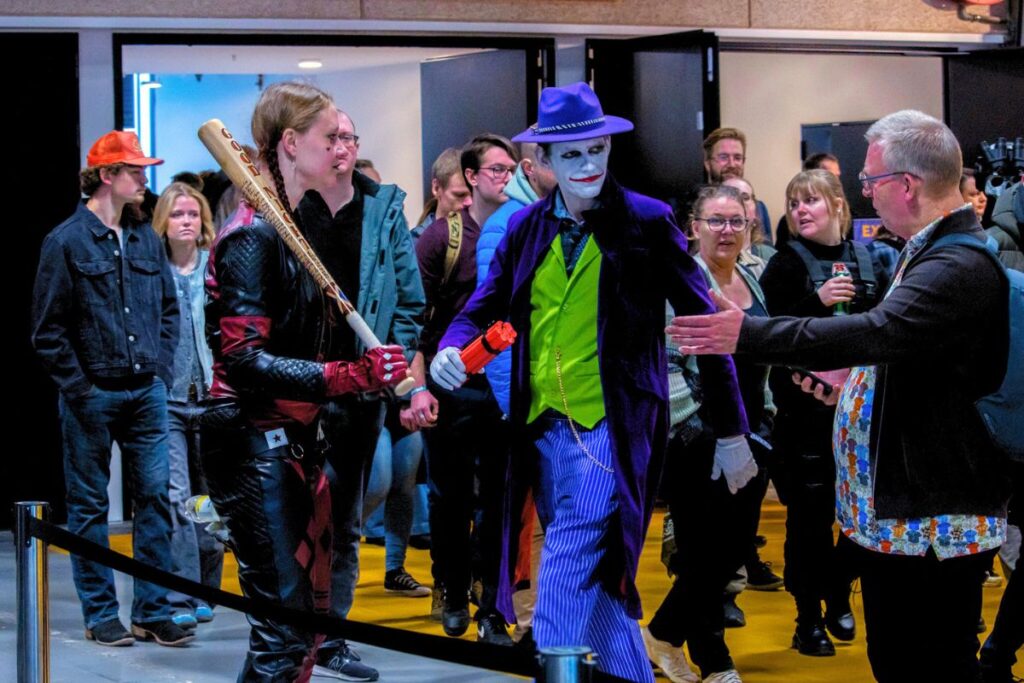 Two cosplayers stepping aside to take a photo