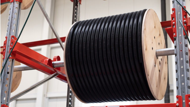 Bundled corrugated conduits on drums