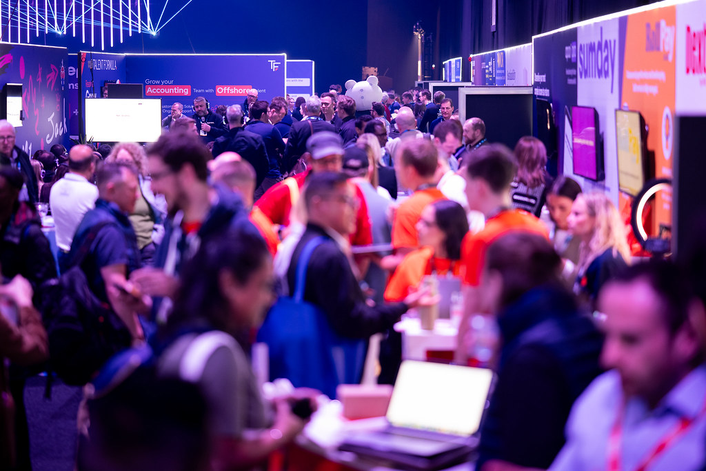 Busy show floor aisles, with lots of people interacting