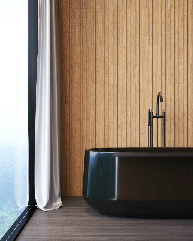 badkamer met zwart bad en houten latjes tegen de wand