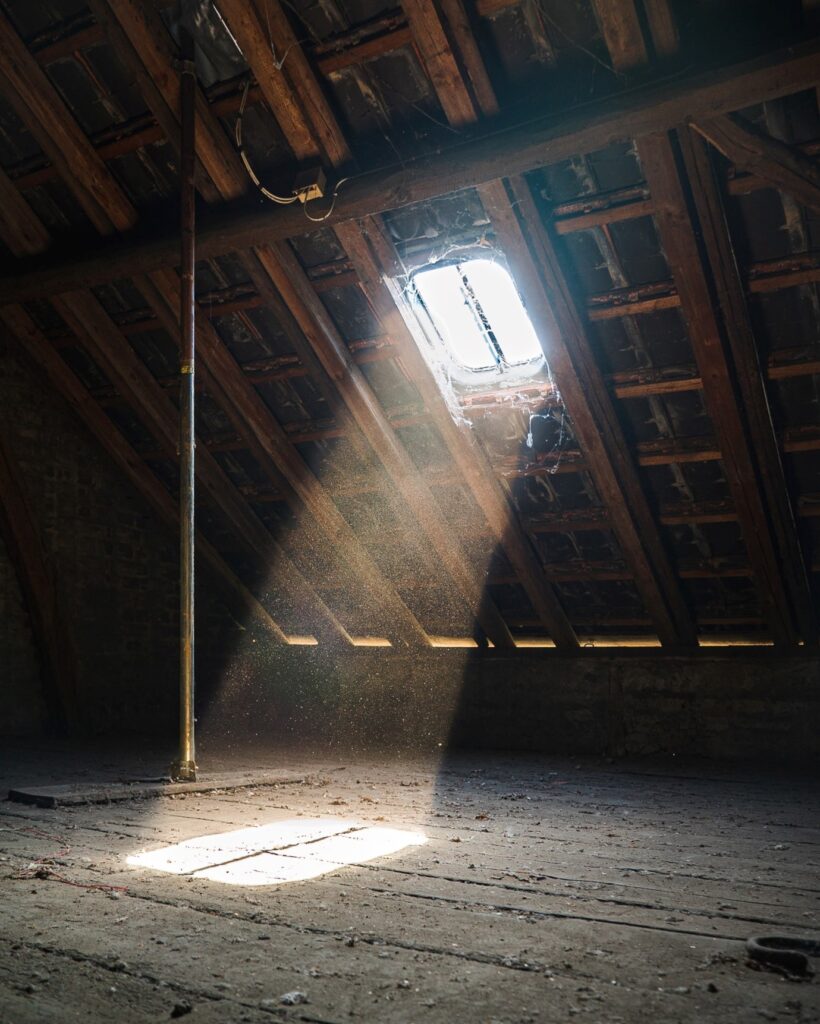 stoffige zolder met zonlicht door het zolderraam