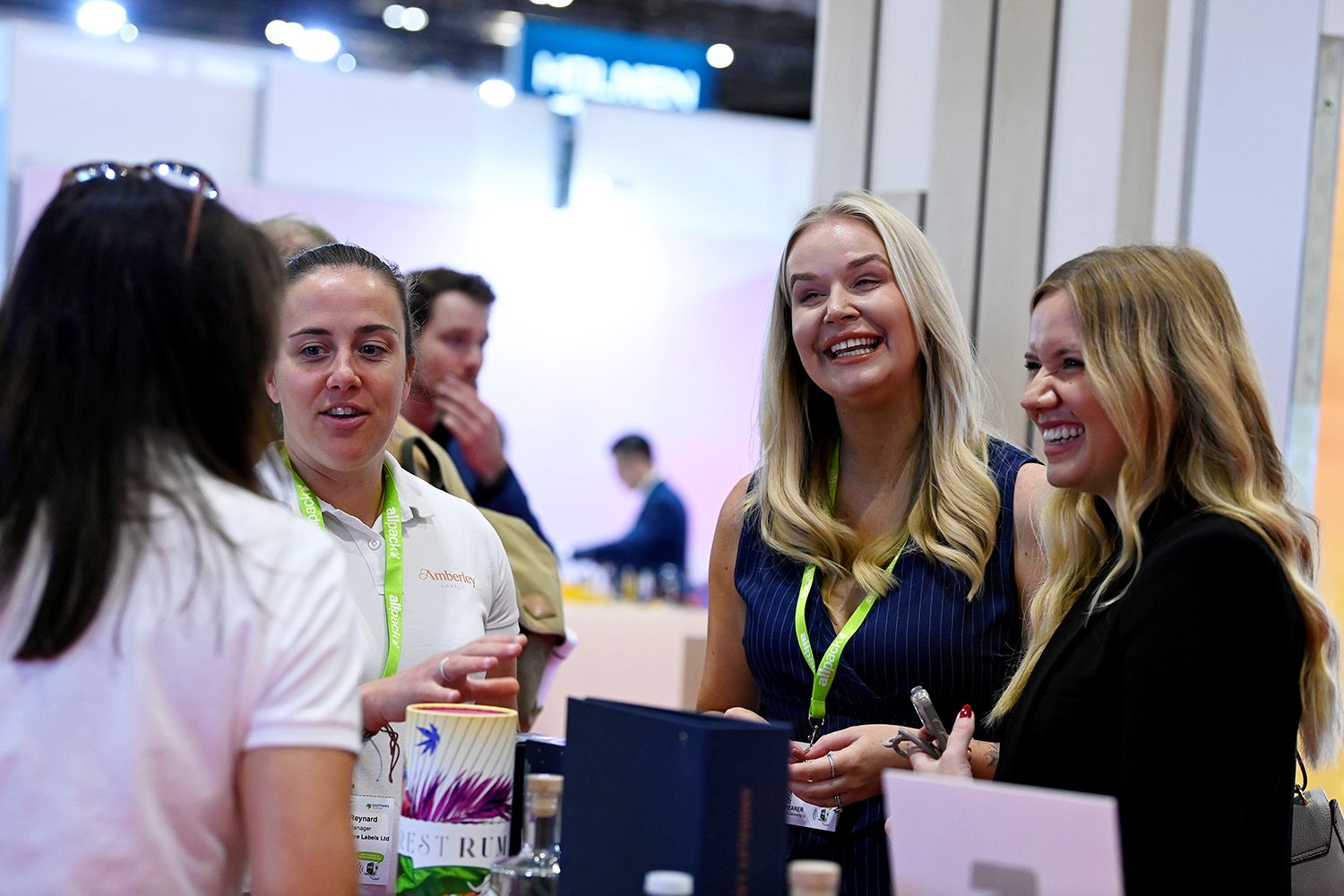 Exhibition visitors speak with exhibitors