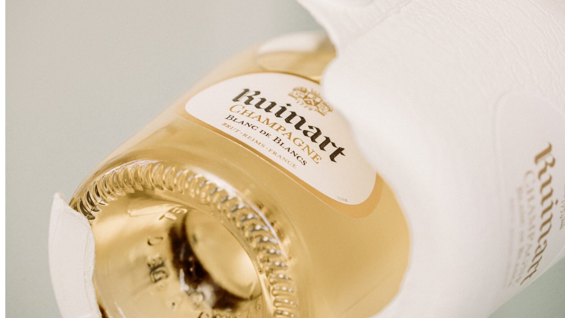 Ruinart champagne bottle in sustainable moulded fibre Second Skin packaging developed by James Cropper.