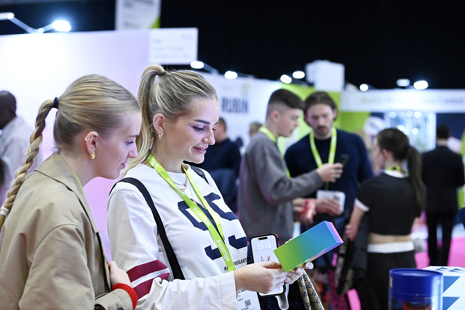 Visitors exploring innovative packaging solutions and examining a premium packaging sample at London Packaging Week.