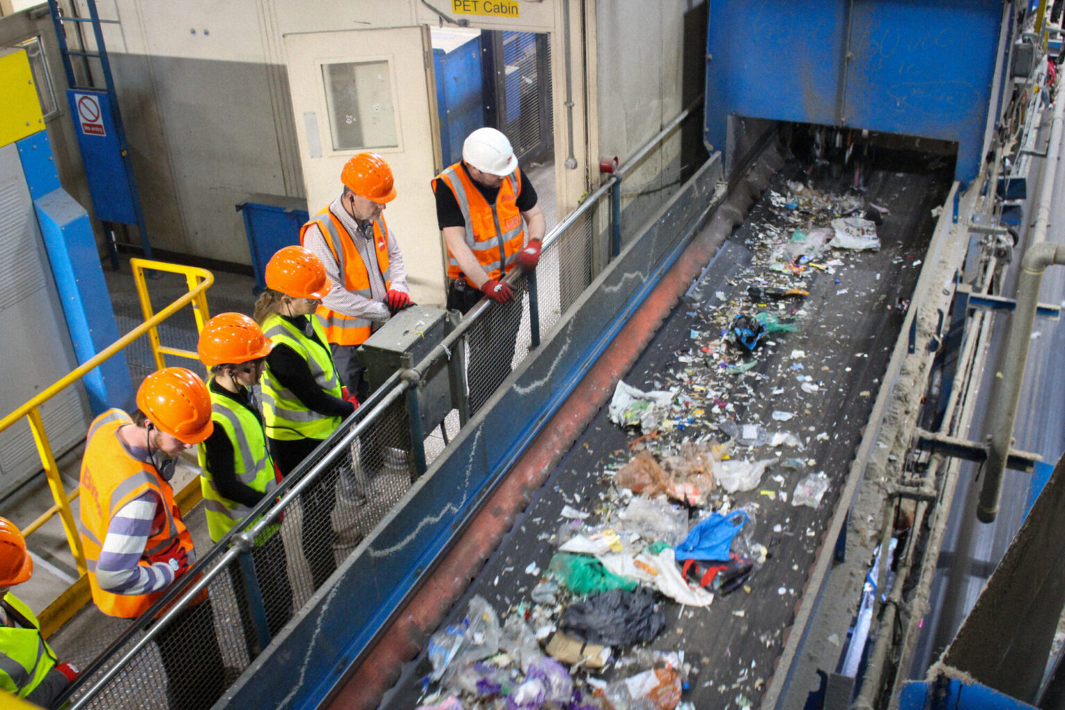 Visitors watching materials move along a recycling sorting line at Biffa’s Edmonton Materials Recovery Facility.