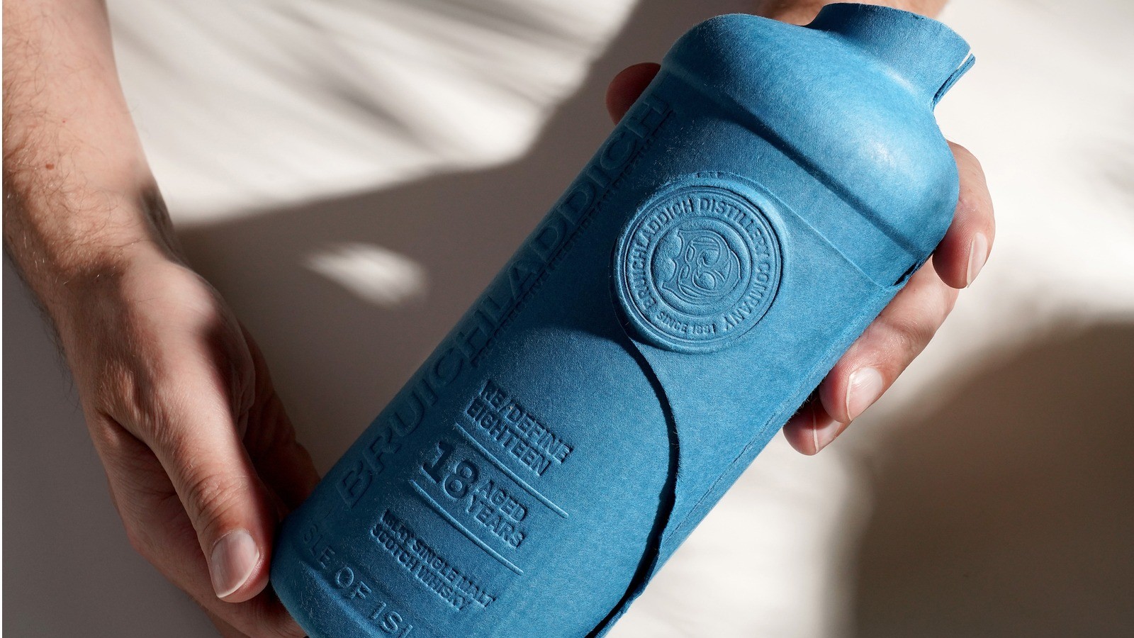 Bruichladdich whisky bottle wrapped in recyclable moulded fibre outer packaging designed to reduce environmental impact.