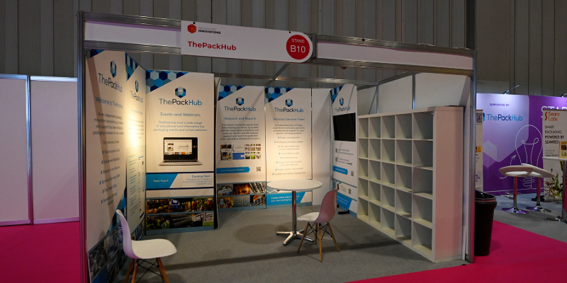 ThePackHub exhibitor stand at Packaging Innovations & Empack displaying reports and services.
