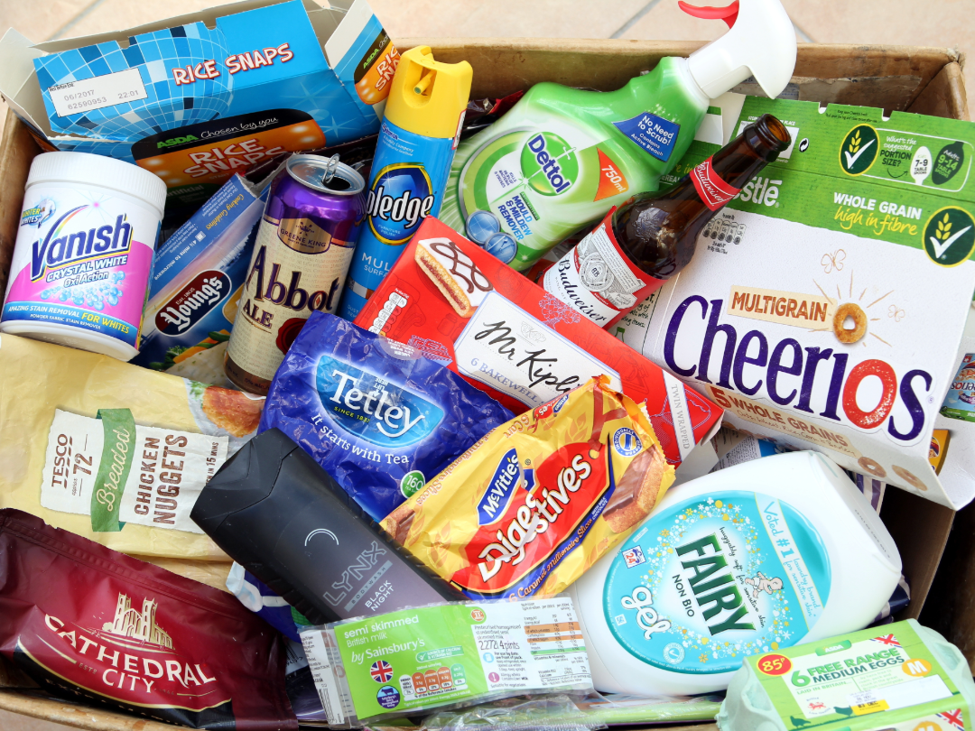 Assorted food, drink, and cleaning products from major UK brands arranged in a box.