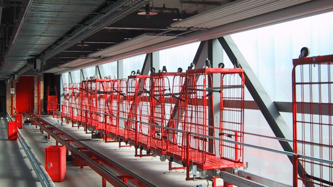CONVEYOR SYSTEMS FOR ROLL CONTAINERS